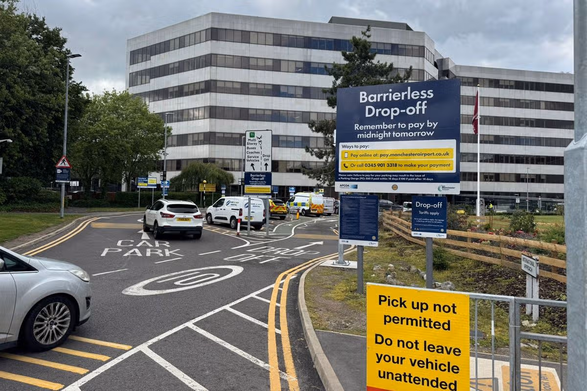 Drop-off signs at a Manchester Airport terminal, showing the pay-by-midnight terms.