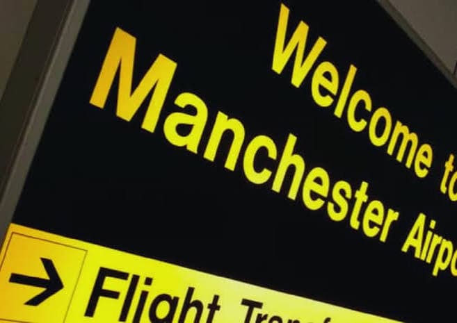 A Manchester Airport direction sign.